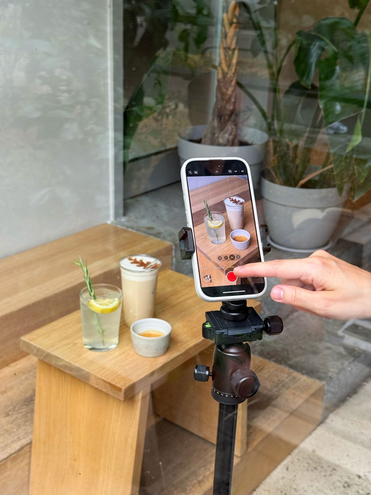 Phone on a tripod filming a styled drink shoot