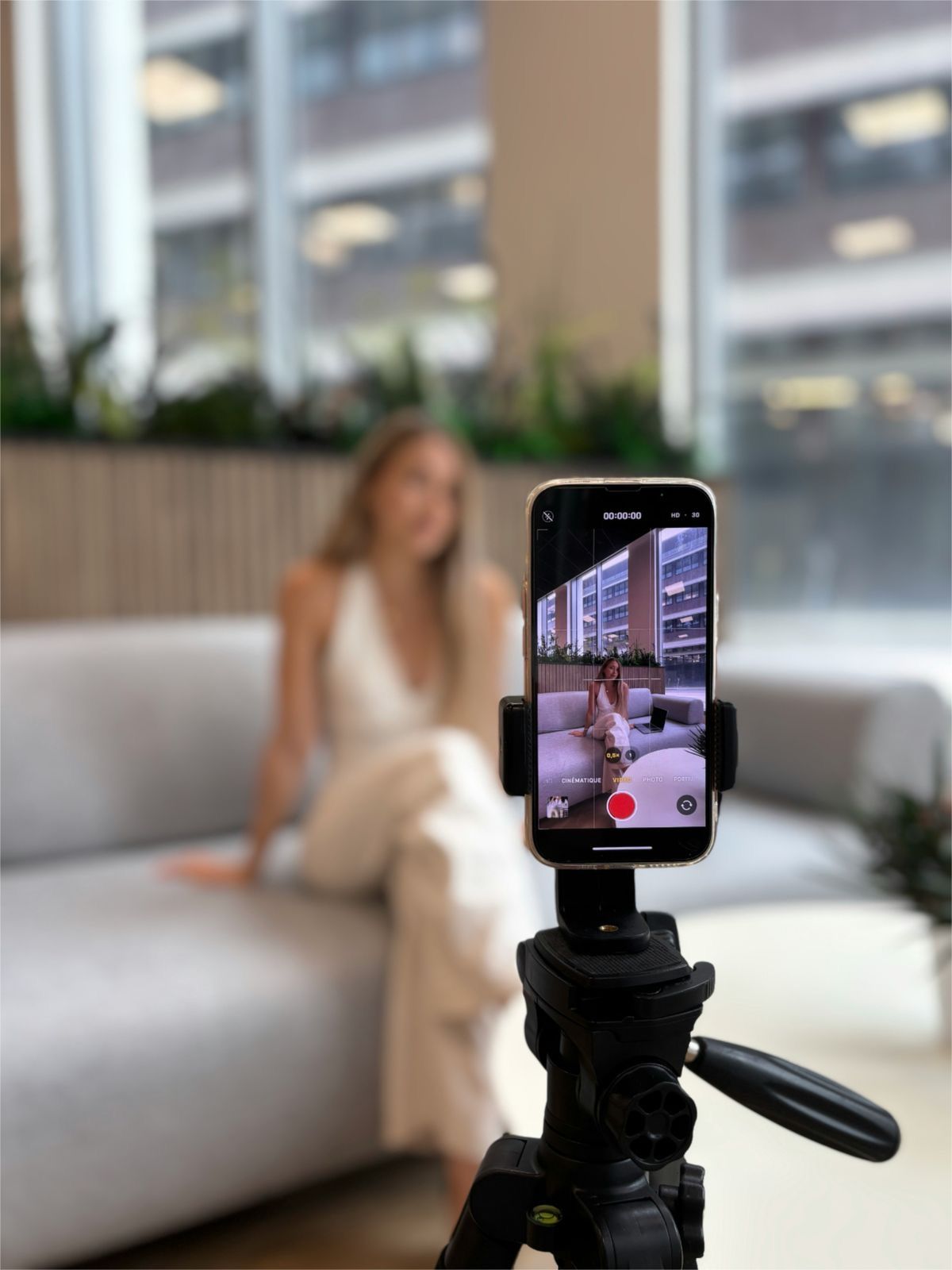 Creator filming UGC content on a phone tripod